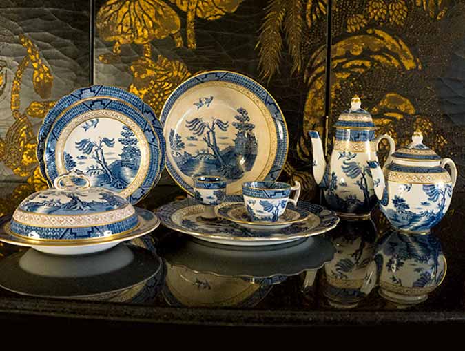 Buy or consign fine china and crystal. See this set of blue Willow china with gold accents at The Ark in La Jolla.