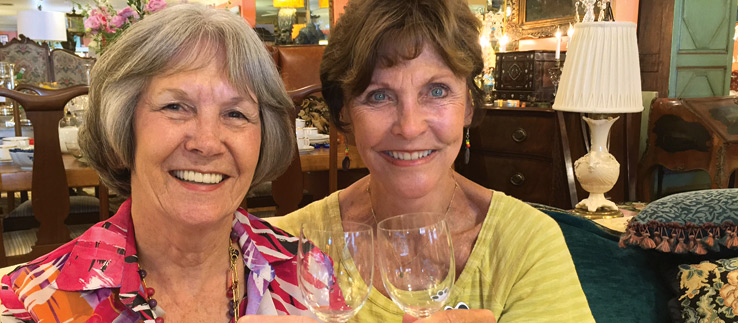 Image of two thirsty volunteers taking time to celebrate The Ark.
