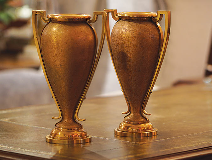 Image of a pair of European Bronze Urns On Bases, double handled, 12 ¾”H.